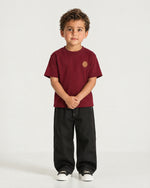 Little boy wearing the Romimi Signature Crest Tee, front view