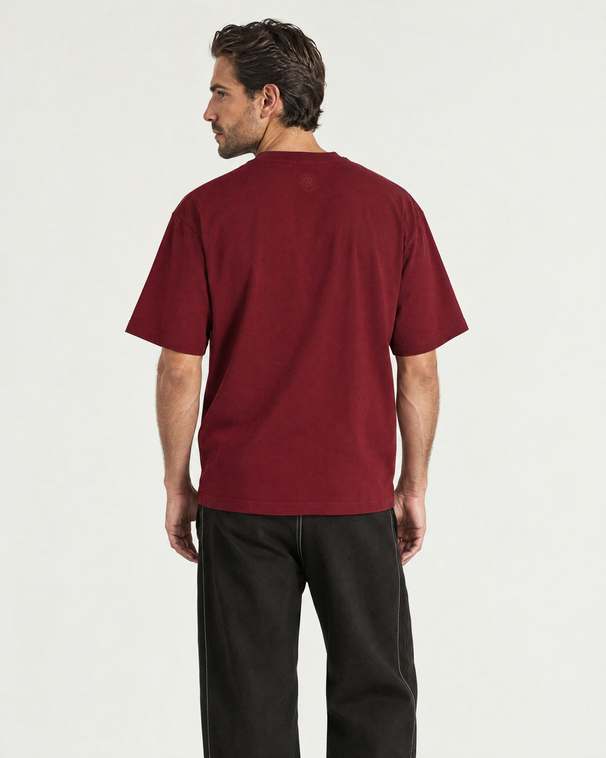 Man wearing the Romimi Signature Crest Tee, back view