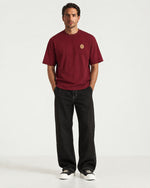 Man wearing the Romimi Signature Crest Tee, full length