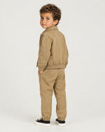 Romimi Slim Tech Suit for kids in Tan, back view, worn