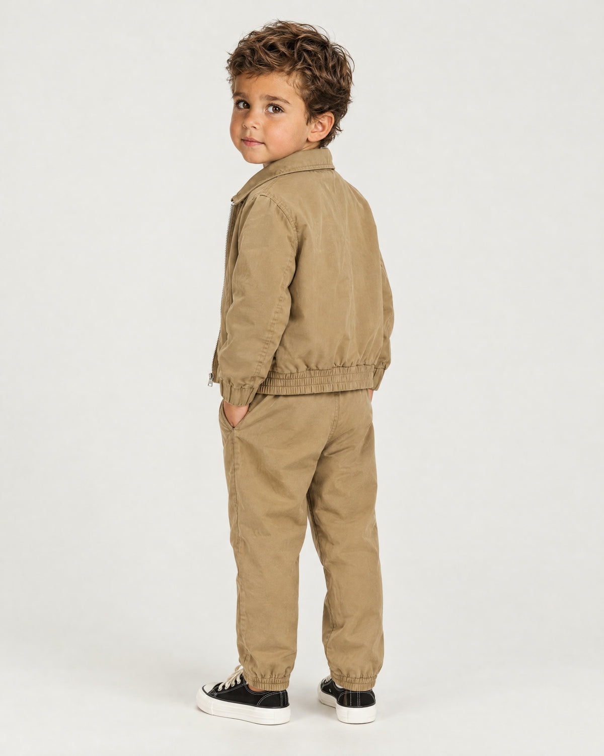 Romimi Slim Tech Suit for kids in Tan, back view, worn