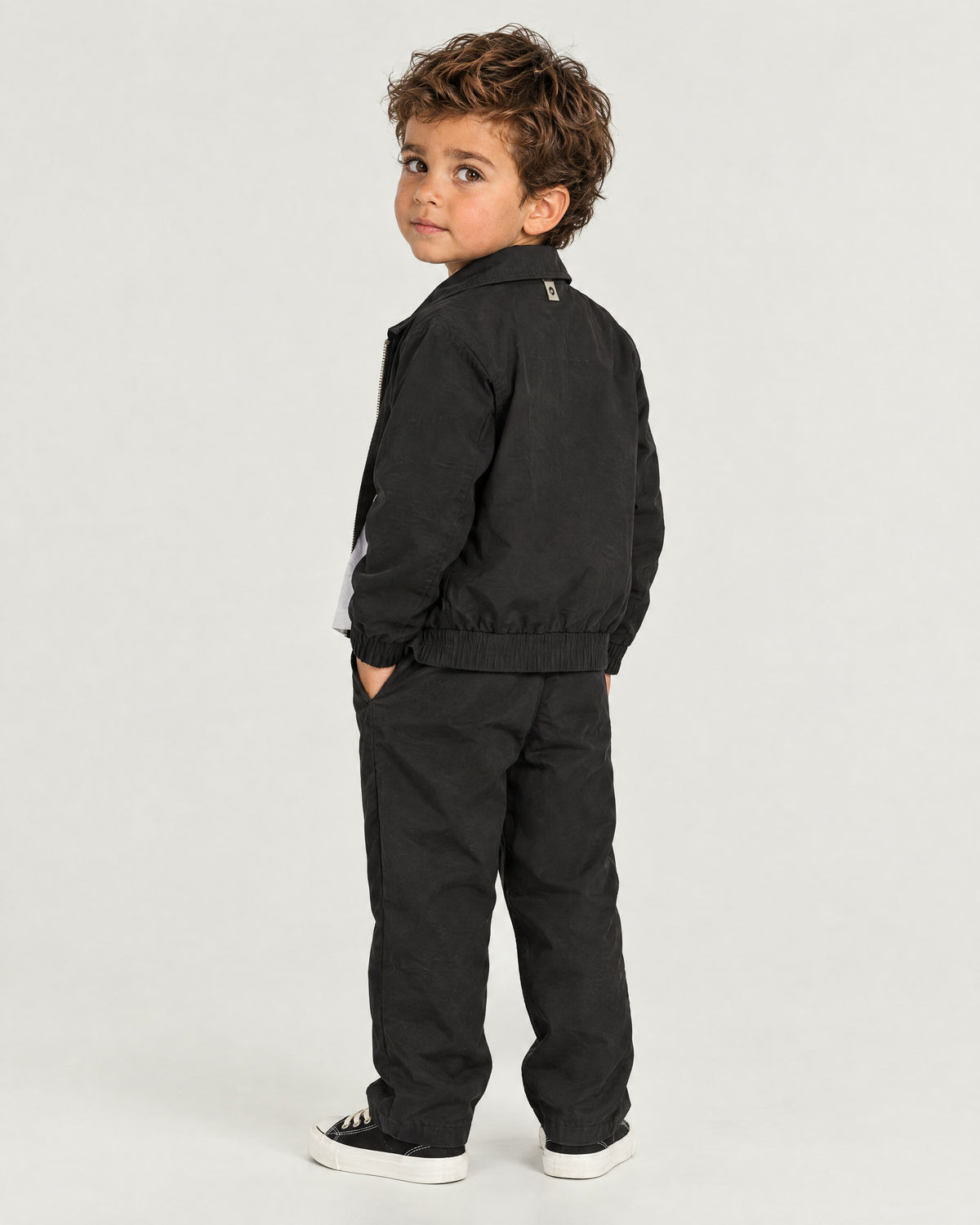 Romimi Slim Tech Suit for kids in Black, back view, worn