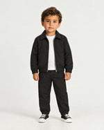 Romimi Slim Tech Suit for kids in Black, worn