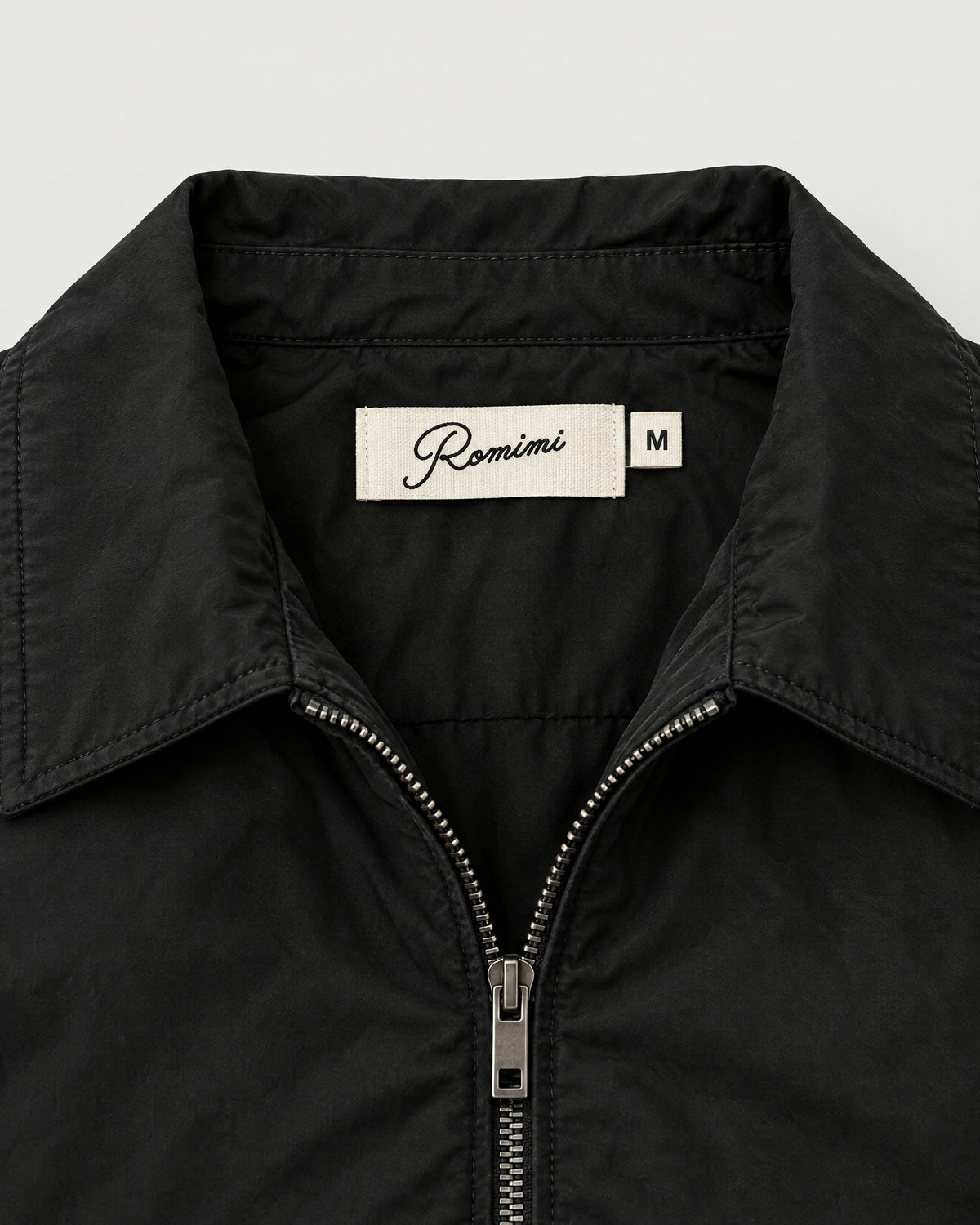Romimi Tech Tracksuit in Black, label close-up