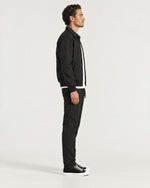 Romimi Tech Tracksuit in Black, side view, worn