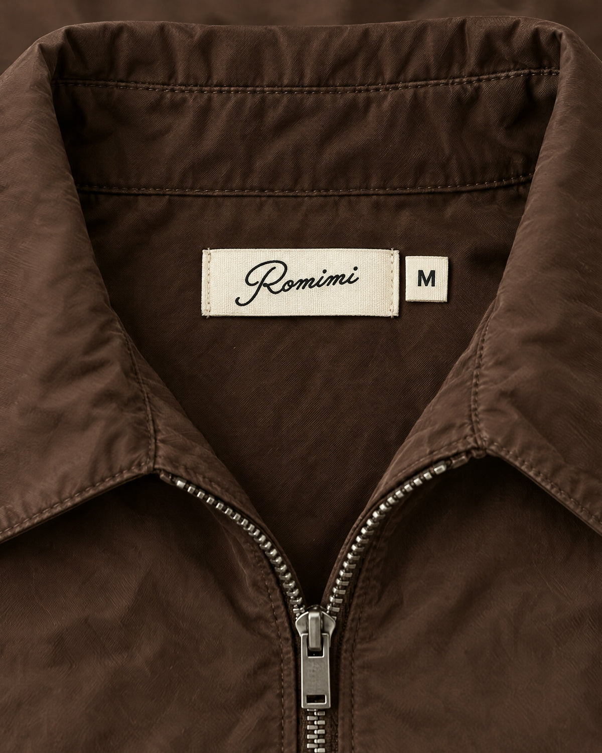 Romimi Tech Tracksuit in Brown, label close-up