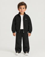 Little boy wearing the Romimi Tracksuit Pant - Black, front view