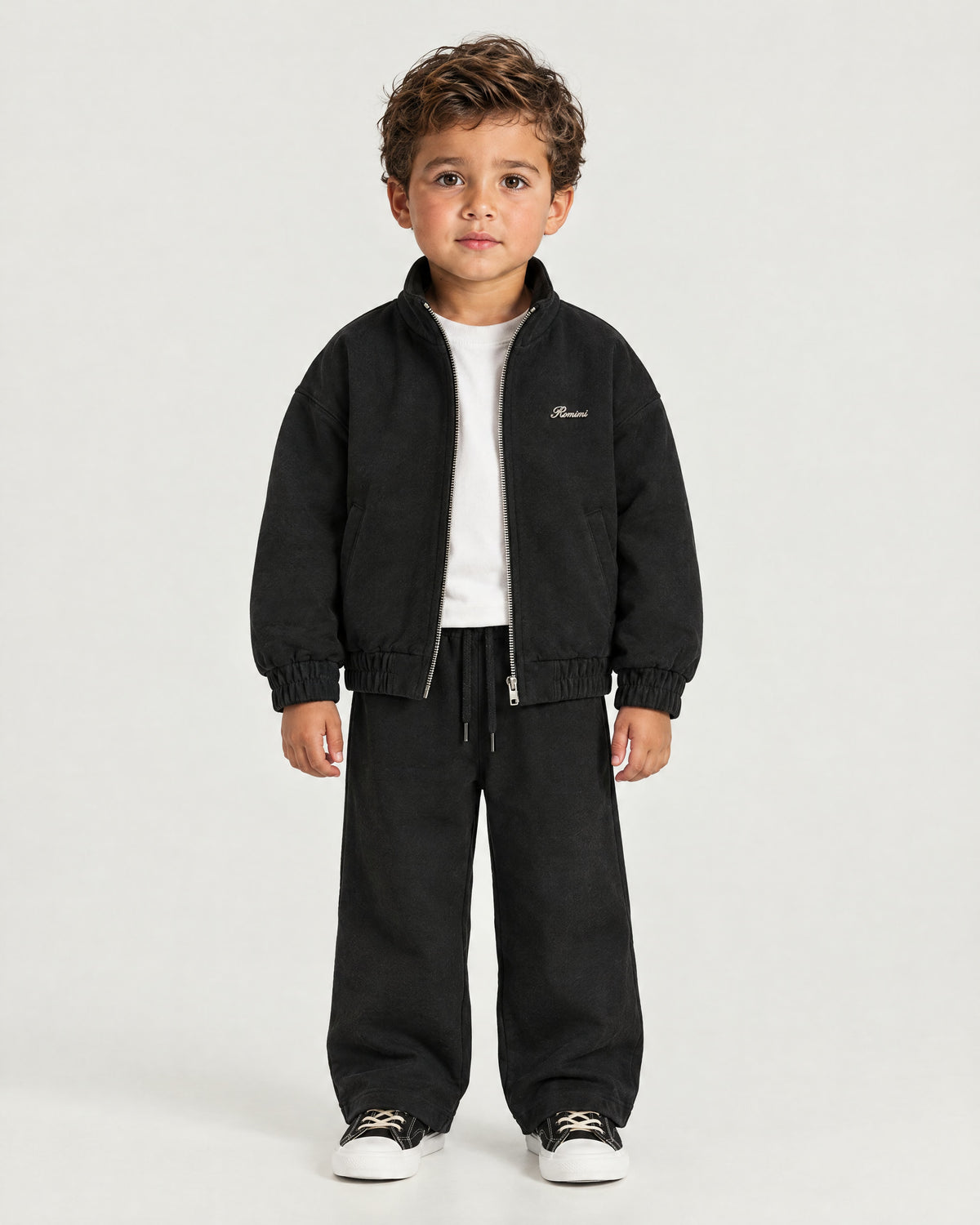 Little boy wearing the Romimi Tracksuit Pant - Black, front view