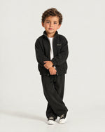 Little boy wearing the Romimi Tracksuit Pant - Black, full length
