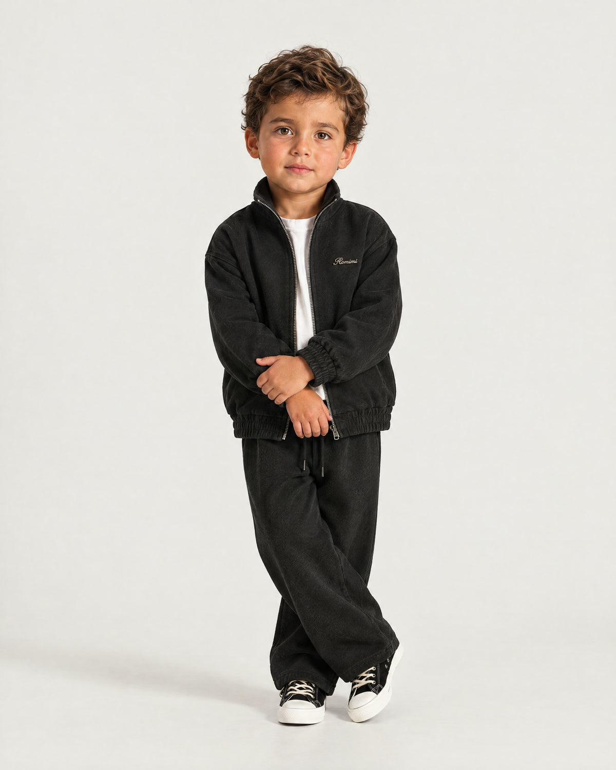 Little boy wearing the Romimi Tracksuit Pant - Black, full length
