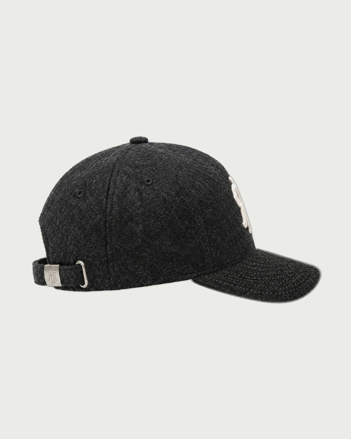 Romimi wool baseball cap in black, side view