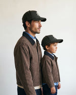 Father and son wearing the Romimi wool baseball cap in dark olive