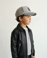 Little boy wearing the kids' wool baseball cap in heather grey, side view