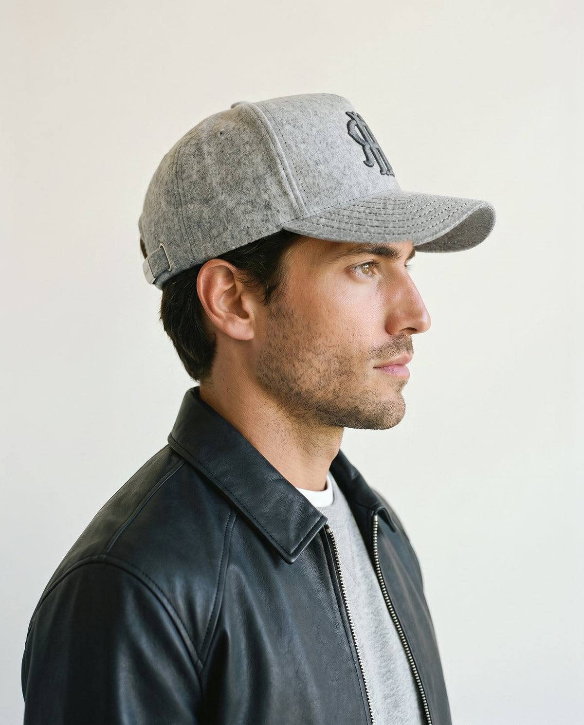 Man wearing the wool baseball cap in heather grey, side view