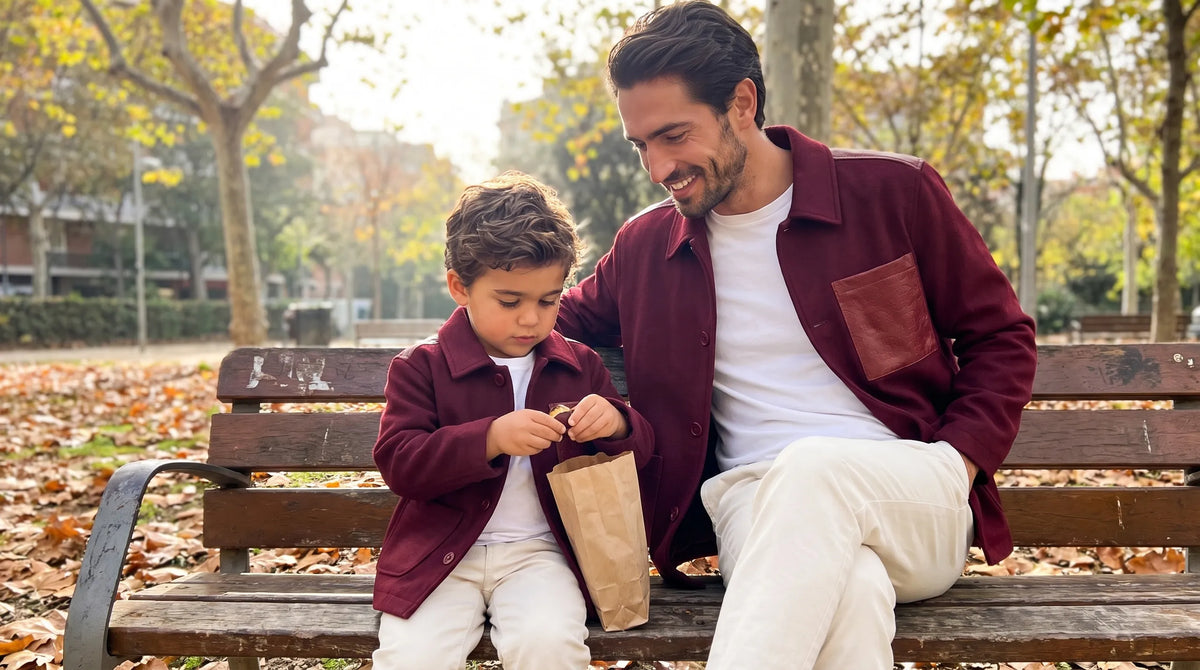 Father and son sharing chestnuts on a park bench in Romimi wool overshirts