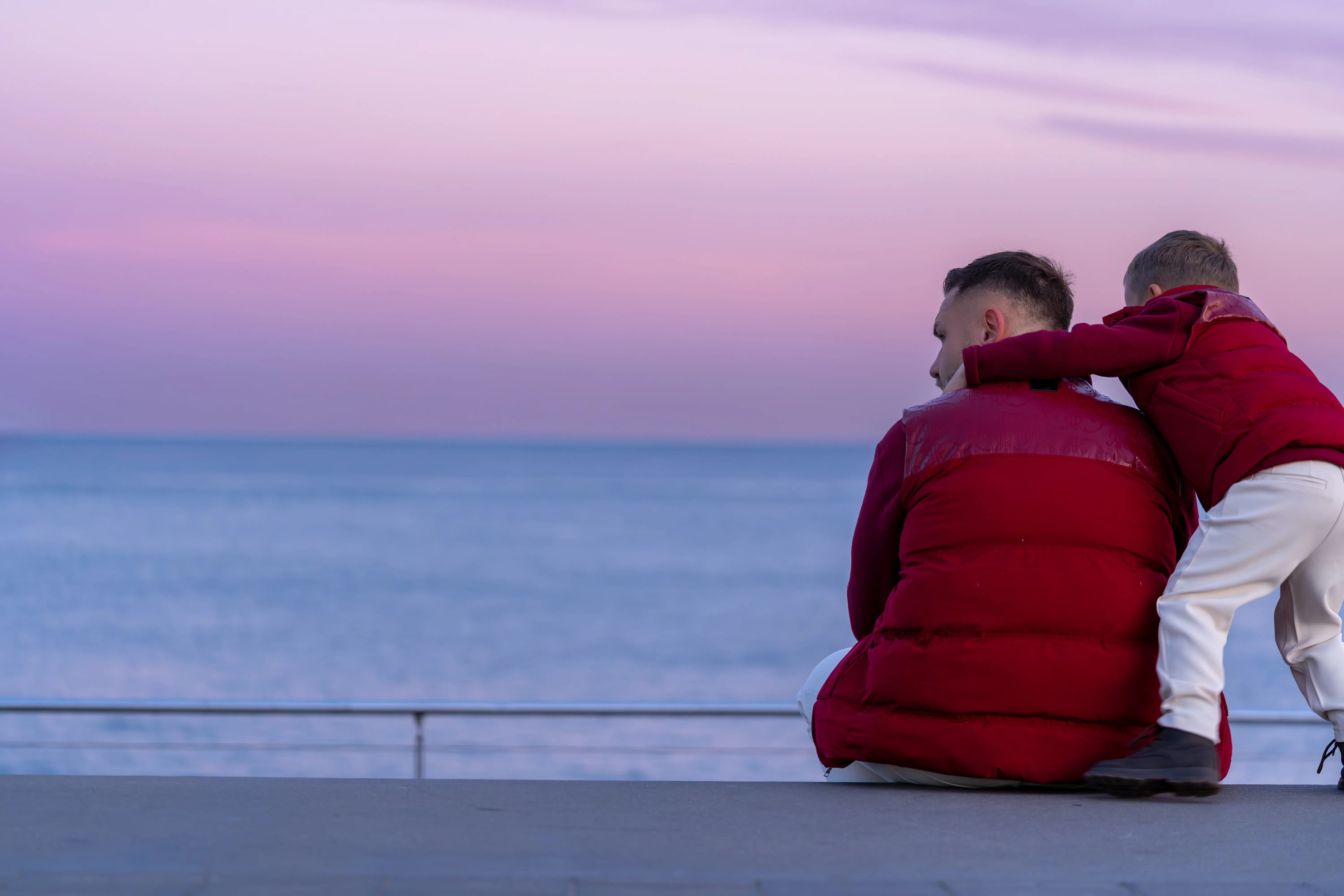 ROMIMI father and son by the sea at dusk
